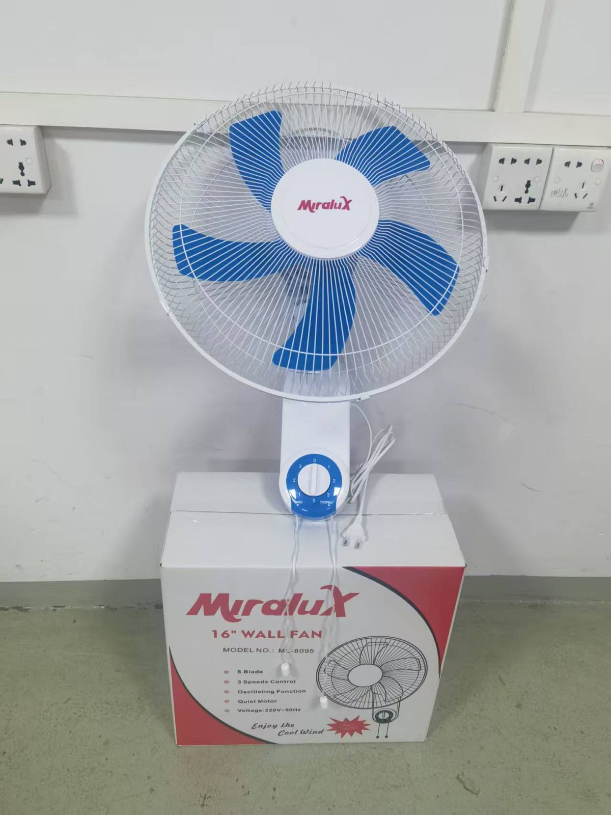 Miralux 16-inch stand fan with blue blades and front grille, on white base