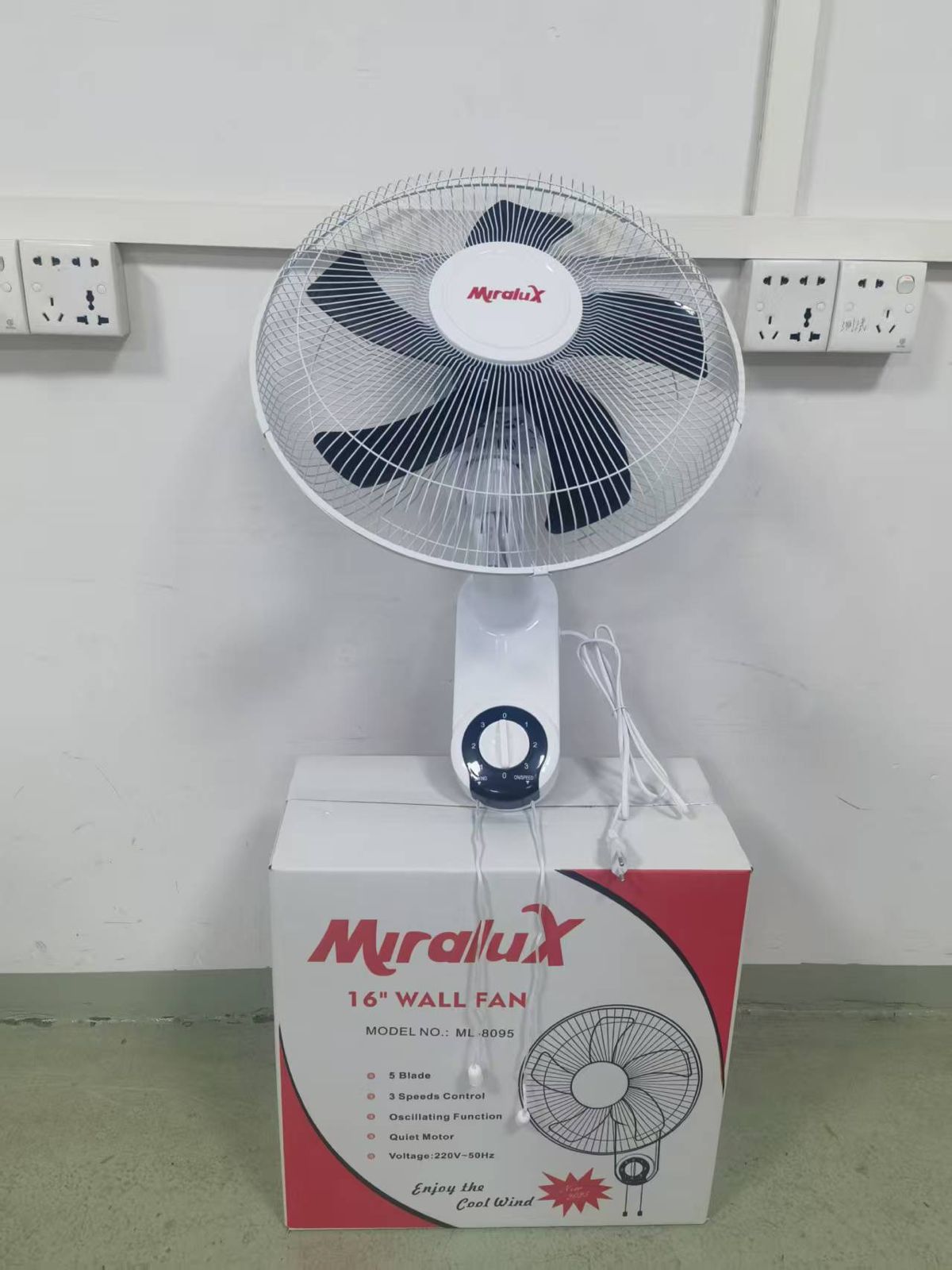 Miralux 16-inch stand fan with dark blades and front grille, on white base
