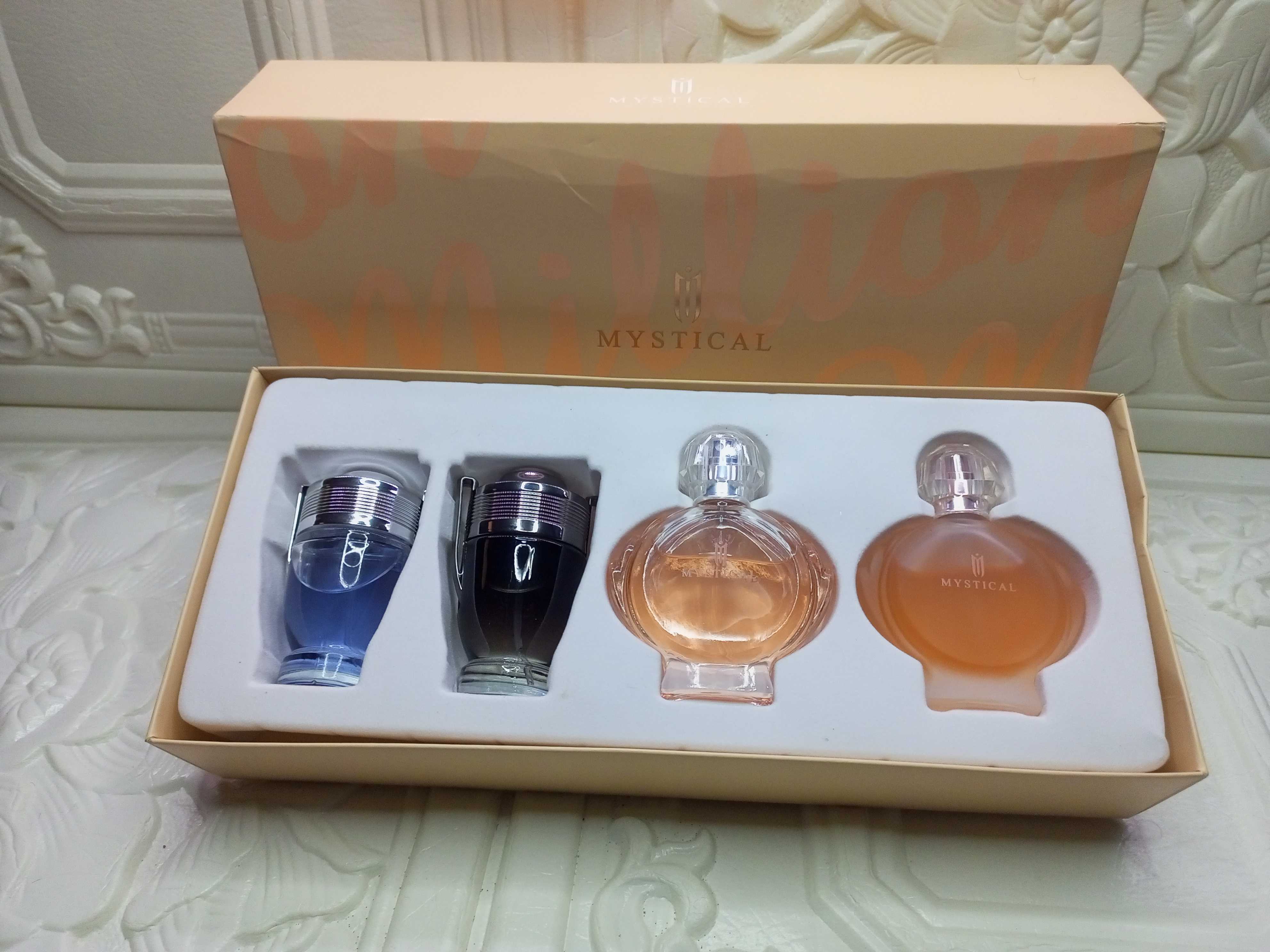 Perfume set gift box with four bottles: two metallic sprays and two amber glass
