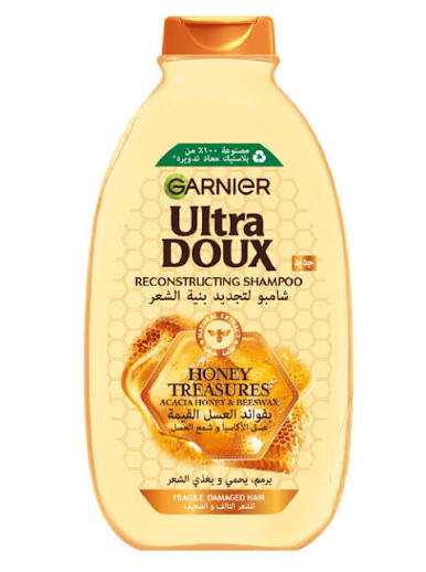 Garnier Ultra Doux reconstructing shampoo bottle with honey graphic, yellow bottle